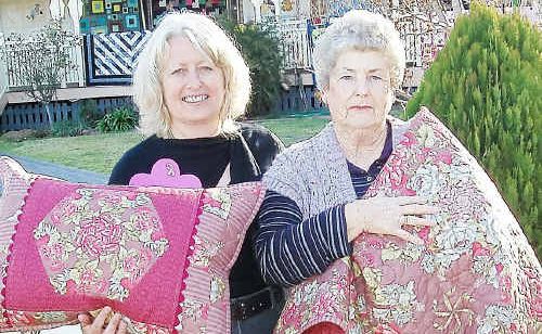 Glenis Pugliese, of Glenrose Patchwork, and Margaret Buchner, (husband Graham won first prize in the raffle) with the winning quilt and pillow. Glenis Pugliese, of Glenrose Patchwork, and Margaret Buchner, (husband Graham won first prize in the raffle) with the winning quilt and pillow.